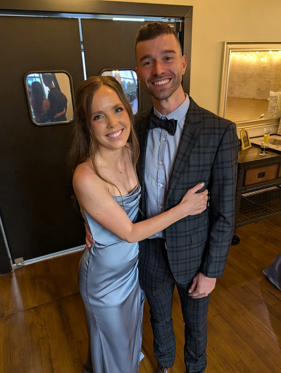 Devon and Ryan Hofsess smiling together at a celebration.